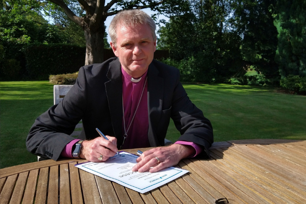 Bishop Mark Tanner signs the paper work registering the diocese's commitment to work towards achieving the status if Eco-Diocese. 